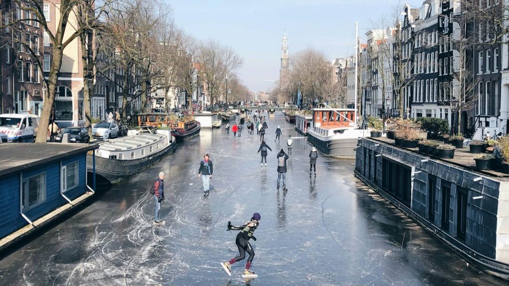 People ice skating on a frozen river