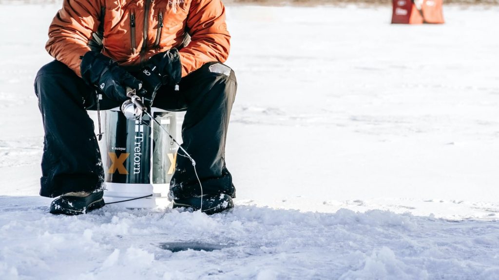 A person practicing ice fishing